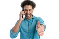 happy greek man with curly hair having a phone discussion and smiling Royalty Free Stock Photo