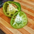 Happy green pepper on a kitchen board