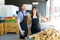 Happy Grocery Workers At Market Stall Royalty Free Stock Photo