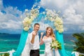 Happy groom and bride with wedding rings under the arch decorate Royalty Free Stock Photo