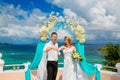 Happy groom and bride with wedding rings under the arch decorate Royalty Free Stock Photo