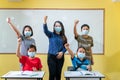 Happy group of asian teacher and children studying in classroom with face mask back at school after covid-19 quarantine and Royalty Free Stock Photo