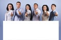 Happy group with blank banner and thumbs up Royalty Free Stock Photo