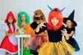 Happy group of children in costumes during Halloween party