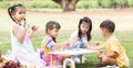 Happy group of cute little children girls painting Easter eggs together. Diverse kids holding painting brush, painting watercolor Royalty Free Stock Photo