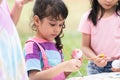 Happy group of cute little children girls painting Easter eggs together. kids holding painting brush, painting watercolor on egg Royalty Free Stock Photo