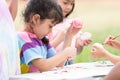 Happy group of cute little children girls painting Easter eggs together. kids holding painting brush, painting watercolor on egg Royalty Free Stock Photo