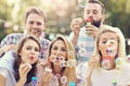 Happy group of friends blowing bubbles outdoors Royalty Free Stock Photo