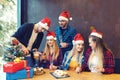 Happy group of friends celebrating Christmas drinking champagne and eating sweet food at dinner party Royalty Free Stock Photo