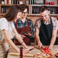 Happy group of friends cooking together in kitchen. Cooking clas Royalty Free Stock Photo