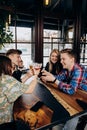 Happy group of friends drinking and clinking with beer and cocktails at brewery bar restaurant Royalty Free Stock Photo