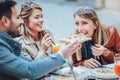 Group of friends eating pizza outdoors Royalty Free Stock Photo