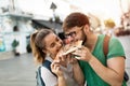 Happy group of people eating pizza outdoors Royalty Free Stock Photo