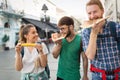 Happy group of people eating pizza outdoors Royalty Free Stock Photo