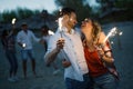 Happy group of friends lighting sparklers and enjoying freedom Royalty Free Stock Photo