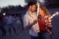 Happy group of friends lighting sparklers and enjoying freedom Royalty Free Stock Photo