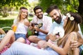 Happy friends in the park having picnic on a sunny day. Royalty Free Stock Photo