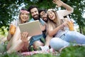 Happy friends in the park having picnic on a sunny day. Royalty Free Stock Photo