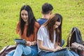 Happy group friends students sitting in park at university Royalty Free Stock Photo