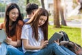 Happy group friends students sitting in park at university Royalty Free Stock Photo