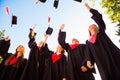 Happy group of graduated young students throwing hats in the air Royalty Free Stock Photo