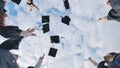 Happy group of graduated young students throwing hats. Royalty Free Stock Photo