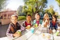 Happy group of international children drinking tea