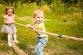 Happy group of kids playing tug of war in a park Royalty Free Stock Photo