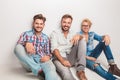 Happy group of men laughing for the camera while sitting Royalty Free Stock Photo