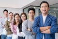 Happy Group portrait of young asian businesspeople standing indoors in office, looking at camera.Successful and confident business Royalty Free Stock Photo