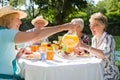 Happy group of senior friends are picnicking in park Royalty Free Stock Photo