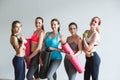 Happy group sporty woman with yoga mats standing