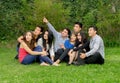 Happy group of students sitting at the park Royalty Free Stock Photo