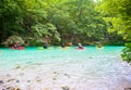 Group traveling by kayak on Acheron river in Greece.