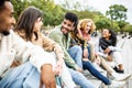 Happy group of trendy young people laughing together sitting outdoor Royalty Free Stock Photo