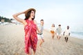 Happy group of young people having fun running at the beach. Funny friends feeling freedom and friendship Royalty Free Stock Photo