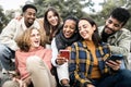 Happy group of young people having fun using smartphone outdoors Royalty Free Stock Photo