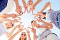 Happy group of young people showing finger gesture and looking down at camera Royalty Free Stock Photo