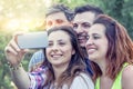 Happy group of young people takes a selfie