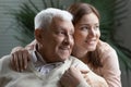 Happy grown granddaughter lean to beloved elderly grandpa giving support