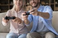Young man have fun playing video games with older mother Royalty Free Stock Photo