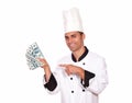 Happy guy in cook uniform holding cash money