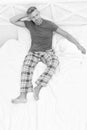 Happy guy in cozy pyjamas daydream resting in bed in morning, daydreaming