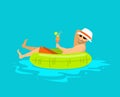 Happy guy floating in inflatable ring in the swimming pool,