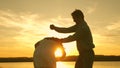 Happy guy and girl waltz in the evening in the summer park. Loving man and woman dance in bright rays of sun on the Royalty Free Stock Photo