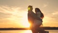 Happy guy and girl waltz in the evening in the summer park. Loving man and woman dance in bright rays of sun on the Royalty Free Stock Photo