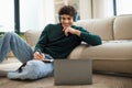 Happy Guy Near Laptop Taking Notes Learning Online At Home Royalty Free Stock Photo