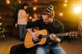 Happy guy is playing guitar. Guy is looking happily and carefree Royalty Free Stock Photo