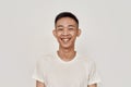 Happy guy. Portrait of young asian man with clean shaven face smiling at camera isolated over white background. Beauty