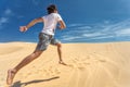 Happy guy running on sand Royalty Free Stock Photo